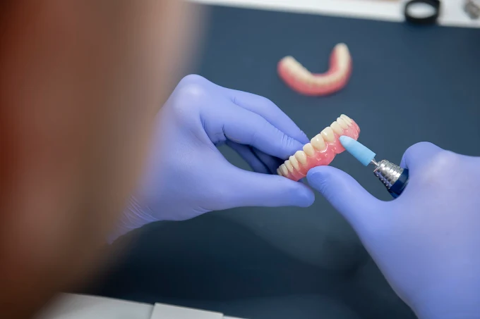 Dental prosthetist at Hancock Denture Clinic fitting dentures in Shoalhaven